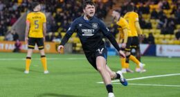 Rangers winger Mikey Moore wheels away to celebrate after scoring their late equaliser