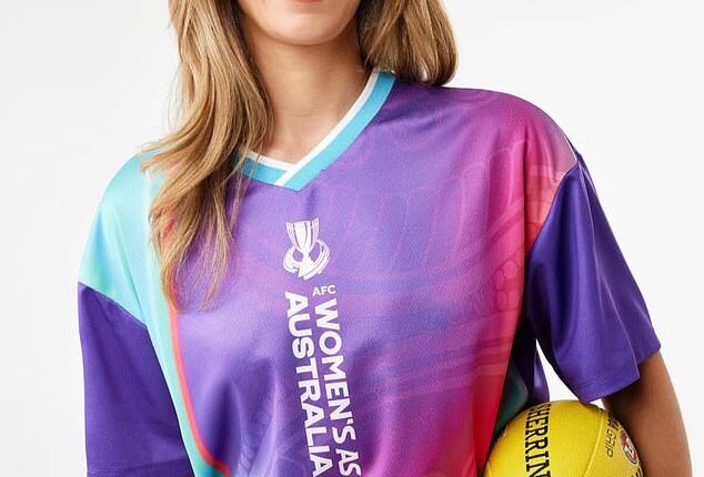 Aussie retailer Kmart has been roasted online following a huge clanger involving the Matildas ahead of the Asian Cup (pictured, a model in Matildas gear while holding an AFL Sherrin footy)