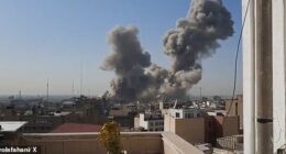 This is the moment women laugh in disbelief as they realise Iran's Supreme Leader Ali Khamenei's compound in Tehran has been hit by an airstrike. Footage shows smoke billowing into the sky above the complex