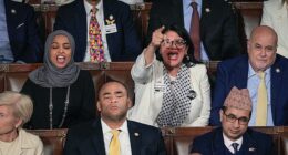 Rep. Rashida Tlaib (D-MI) (R) and Rep. Ilhan Omar (D-MI) shout during U.S. President Donald Trump's State of the Union address on Tuesday