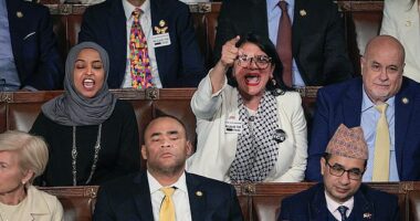 Rep. Rashida Tlaib (D-MI) (R) and Rep. Ilhan Omar (D-MI) shout during U.S. President Donald Trump's State of the Union address on Tuesday