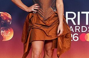 Sian Welby put on a leggy display in an autumnal corset dress as she kicked off the star-studded BRITs red carpet at the Co-op Live in Manchester on Saturday