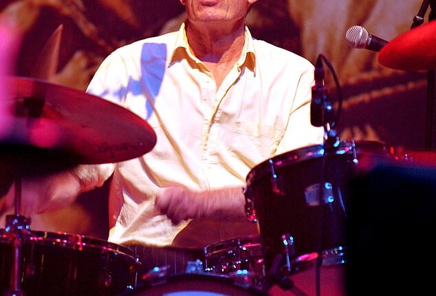 Tributes have been paid to Andrew Ranken, drummmer with the Pogues, after his death aged 72 - he is pictured here performing at the Apollo in Manchester in December 2013