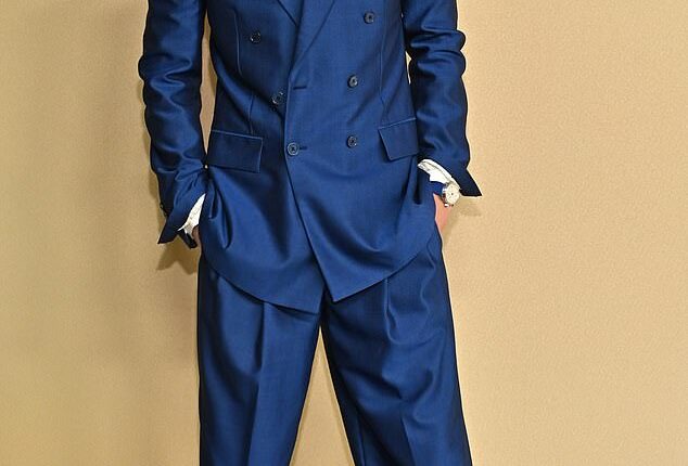 Drove past the tailor? Actor Timothee Chalamet wore a dark blue, satin pantsuit to the pre-Oscars luncheon, but the ensemble didn't seem to fit him quite right. The pants were a bit wrinkled, too, as they looked in need of an iron. He completed the look by pairing it with a white, button-down shirt underneath and a pair of black boots