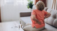 A woman with back pain. Over 34 per cent of people asked in a survey thought a recurring ache that does not disappear (34 per cent) is an indicator you are getting old (file image)