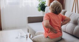 A woman with back pain. Over 34 per cent of people asked in a survey thought a recurring ache that does not disappear (34 per cent) is an indicator you are getting old (file image)