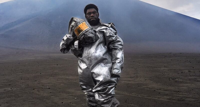 Winner of the Portrait category is Ellie Leontiev's 'The Barefoot Volcanologist.' It shows a volcanic scientist standing on a volcanic rock bomb in Vanuatu