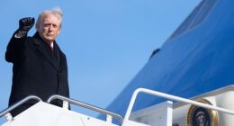 President Donald Trump gives the press a fist bump after boarding Air Force One last week. On Monday, he told podcaster Dan Bongino that he takes the steps 'nice and slow' after mocking President Joe Biden's repeated stumbles