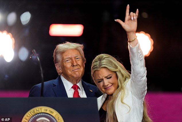 Donald Trump stands with Erika Kirk at the conclusion of a memorial for her husband, conservative activist Charlie Kirk, in Glendale, Arizona, September 21