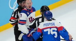 Officials separate United States' Brady Tkachuk (7) and Slovakia's Martin Pospisil (76) during the first period of Team USA's semifinals win on Thursday in Milan, Italy