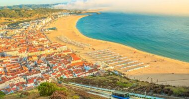Portugal's authentic villages and well-preserved beaches, such as that of the surfing town of Nazare (pictured), lend a gentler appeal than next-door Spain