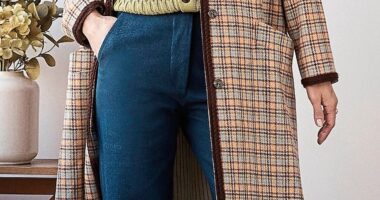 Coat, £550, and trousers, £160, kipper.club. Cardigan, £110, peregrineclothing.co.uk. Brooch, £495, alexmonroe.com. Trainers, £110, communityclothing.co.uk.