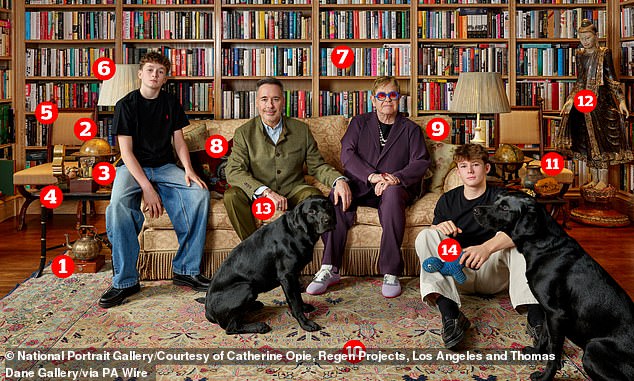 Sir Elton John has offered a rare glimpse into his family's home in a new portrait (pictured) that has been unveiled at London's National Portrait Gallery. Pictured one to 14: a copper teapot, a desk globe, a £152 diffuser, a TV award, vintage chairs, stylish lamps and floor-to-ceiling bookshelves, a Gucci cushion, a statement sofa, a patterned rug, a colourful vase, a standing Buddha sculpture, a Cartier love bracelet and a Pets at Home dog toy
