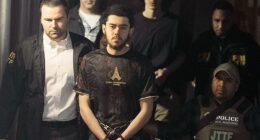 Ibrahim Kayumi (front) and Emir Balat (back) in federal custody leaving the NYPD's 26th Precinct stationhouse in Manhattan on Monday