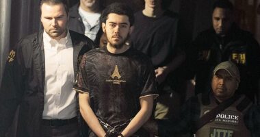 Ibrahim Kayumi (front) and Emir Balat (back) in federal custody leaving the NYPD's 26th Precinct stationhouse in Manhattan on Monday