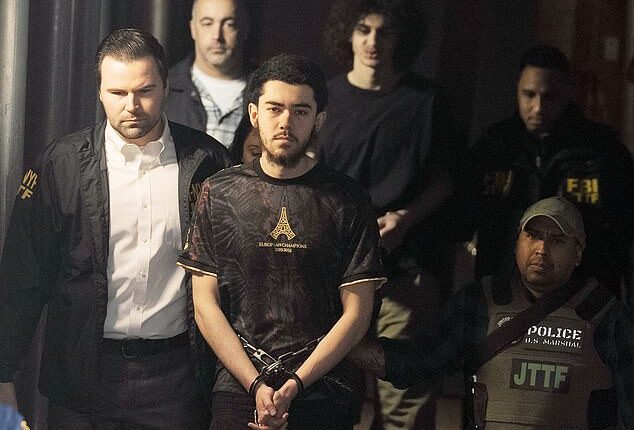 Ibrahim Kayumi (front) and Emir Balat (back) in federal custody leaving the NYPD's 26th Precinct stationhouse in Manhattan on Monday