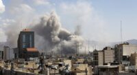 Plumes of smoke rise over the residential areas of the Iranian capital following airstrikes amid ongoing US and Israeli attacks as multiple explosions are heard across the city in Tehran, Iran on March 1, 2026