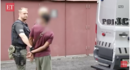 A U.S. law enforcement officials arrests a foreign national.