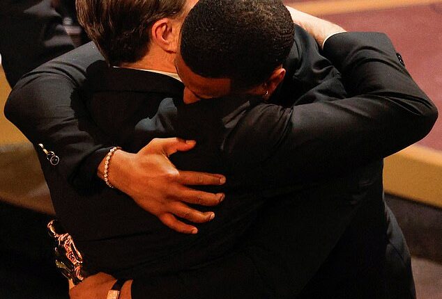 Michael B. Jordan enjoyed tight embrace from Leonardo DiCaprio after beating him for best actor - more than a decade on from DiCaprio's 2015 win in the same category for The Revenant