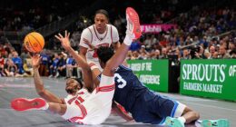 Houston's Joseph Tugler (11) passes as BYU's AJ Dybantsa (3) defends during the first half of an NCAA college basketball game in the quarterfinal round of the Big 12 Conference tourney