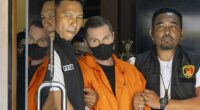 Steven Lyons is escorted by police officers at the Bali Police headquarters in Denpasar, Bali, Indonesia, March 31 2026