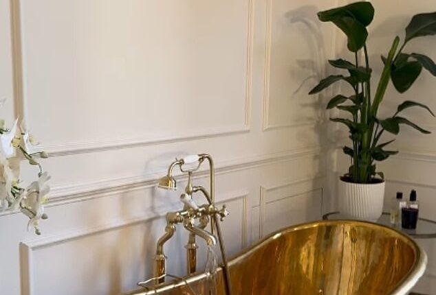 Millie Mackintosh's extensive renovation of her £5million home includes a large, sprawling bathroom fit with high ceilings, a copper bath tub and a spot of greenery