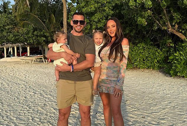 Charlotte Crosby has revealed her fiancé Jake Ankers was rushed to hospital on Monday night after suffering 'severe chest pains' (pictured together with their daughters Alba and Pixi)