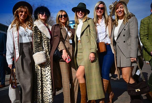 Here come the girls! A group of glamorous ladies pose for the camera as they attend the first day of the Cheltenham festival