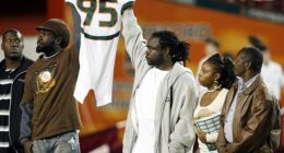 Bryan Pata's family holds up his jersey at the beginning of a college football game back in 2006