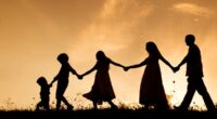 family silhouette against sunset