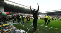 An ultra turns to face the Celtic fans in the Broomloan Stand after making his way on the pitch