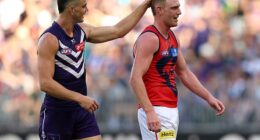Pictured: Fremantle star Patrick Voss ruffles Harrison Petty's hair as he taunted him during the match against Melbourne on Saturday