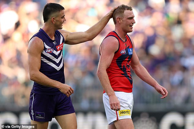 Pictured: Fremantle star Patrick Voss ruffles Harrison Petty's hair as he taunted him during the match against Melbourne on Saturday