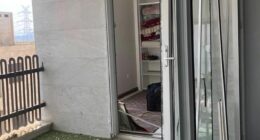 A harrowing photograph sent to the Daily Mail shows the aftermath of a nearby strike on a Pardis apartment: balcony doors blown out, reduced to a jagged skeleton of metal and glass