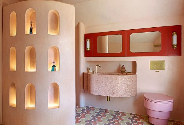 In this bathroom by Owl Design, the walls, ceiling and shower enclosure are clad in a putty-pink Tadelakt plaster, with a candy-pink loo by Trone and pastel floor tiles from Mosaic Factory.