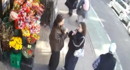 Two women could be seen chatting while doing their makeup on the sidewalk in Manhattan