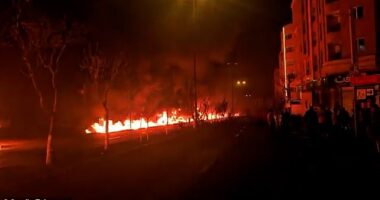 Uncl grabs: Moment fire flows through the streets of Tehran in apocalyptic scenes after after US strikes on oil depots