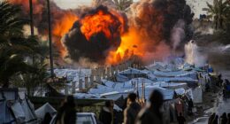 A fireball erupts following an Israeli strike near a tent encampment sheltering peope displaced by war in the central Gaza Strip on March 25