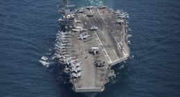 Tehran claimed it had fired ballistic missiles at the $1.8billion USS Abraham Lincoln aircraft carrier (pictured), adding it had to 'change position' after the barrage in the Arabian Sea.