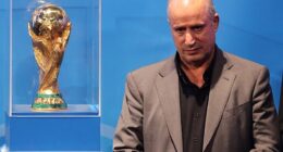 Iranian Football Federation president Mehdi Taj (pictured with the men's World Cup trophy) has launched an unhinged attack on Australia, accusing the government of abducting and taking players from the national women's team hostage