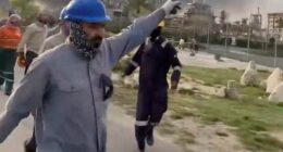 Pictured: Workers evacuate area around Saudi Aramco's Ras Tanura oil refinery as smoke rises following a reported Iranian drone strike
