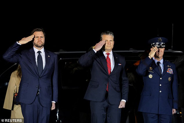 JD Vance (pictured left) oversaw the dignified transfer of the seventh US service member to die in the Iran war after Donald Trump admitted his vice president is 'less enthusiastic' about the conflict