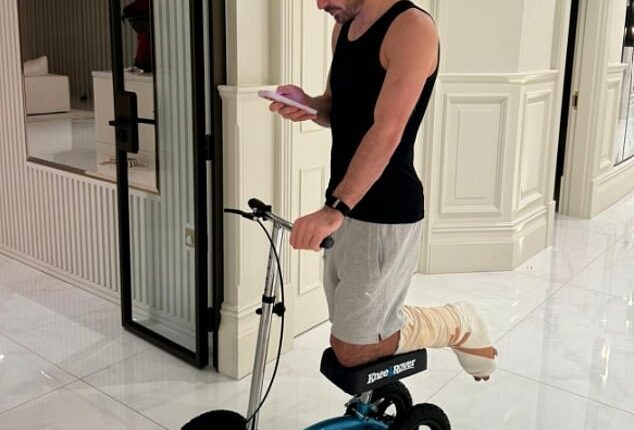 Jack Grealish is using a knee stool to rest his injured left foot after surgery last month