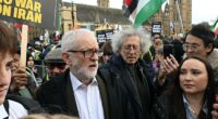 Jeremy Corbyn (centre left) was seen with his brother Piers (centre right) alongside supporters of the regime at a rally in Parliament Square on Saturday