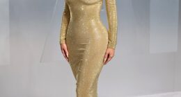 Kim Kardashian embraced Oscars gold as she made her grand entrance to the Vanity Fair Oscar Party