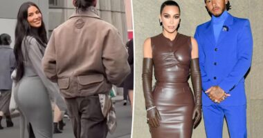 Kim Kardashian smiles at fans while strolling arm in arm with Lewis Hamilton in Tokyo