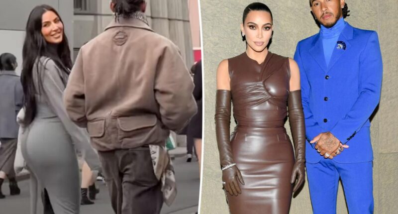 Kim Kardashian smiles at fans while strolling arm in arm with Lewis Hamilton in Tokyo