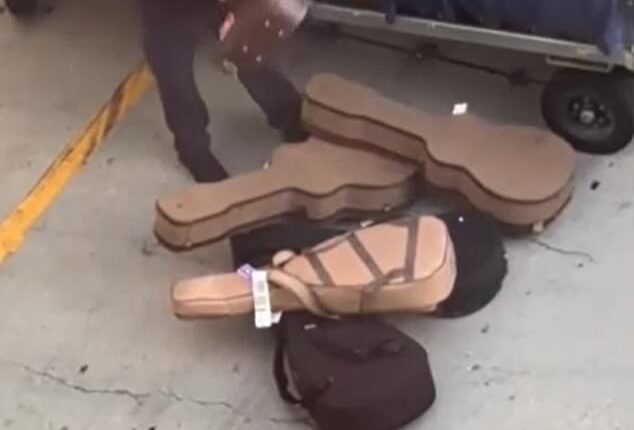 A careless baggage handler at LAX was captured tossing guitars on the floor while unloading a luggage cart on March 16