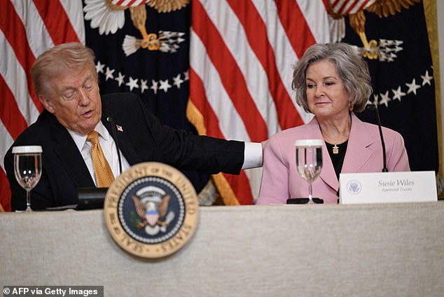 President Donald Trump pats his chief of staff Susie Wiles on the shoulder during their first public appearance after the announcement of her breast cancer diagnosis