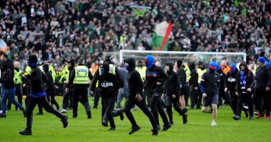 Supporters spill on to the Ibrox pitch during Sunday's controversial Old Firm clash